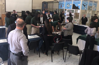 Project Rebound from Sacramento State University (left) and youth peruse tables (right) at the northern complex resource fair held Thursday, Nov. 7, 2019. Photos by Rachel Stern.