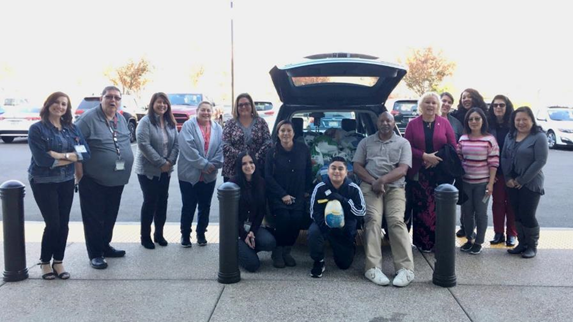  Headquarters staff poses with a carload of turkeys donated for the State Employees Holiday Food Drive. 