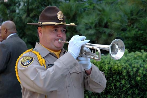 Correctional officer plays bugle at Medal of Valor ceremony in 2005.