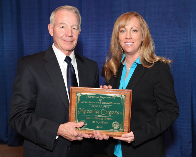 Recipient of employee recognition award with secretary. 