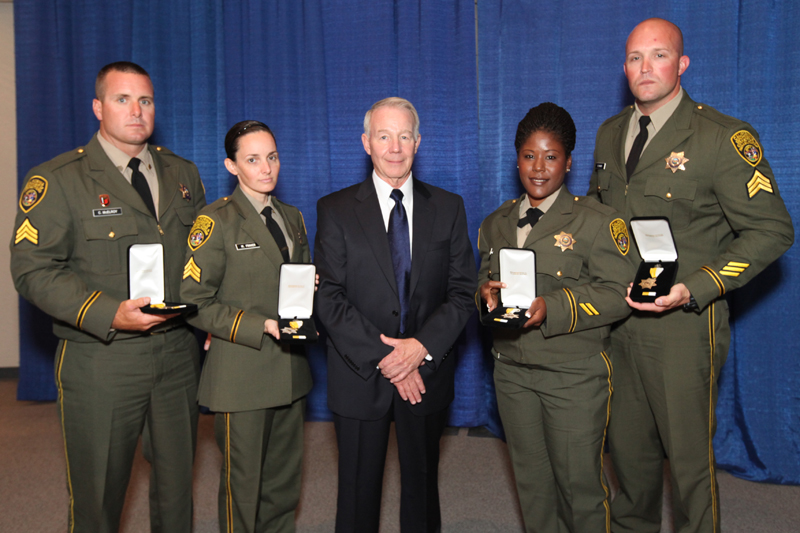 Four people with awards.