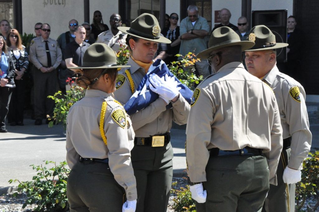 The San Quentin honor guard folds the flag at the Sergeant Burchfield memorial 30th anniversary.