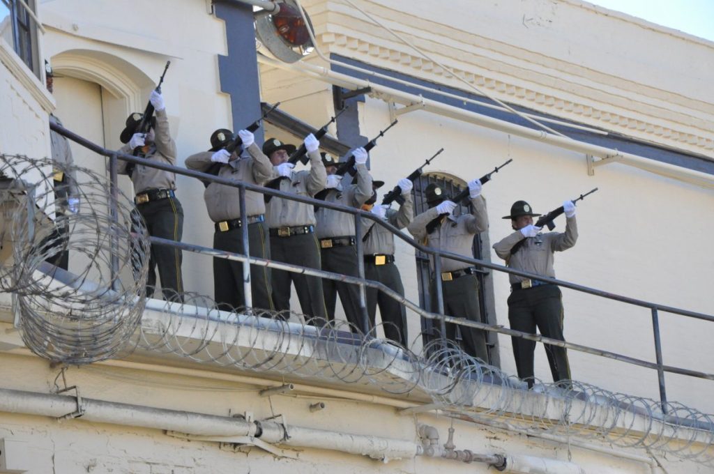 A gun salute in honor of a San Quentin slain sergeant.