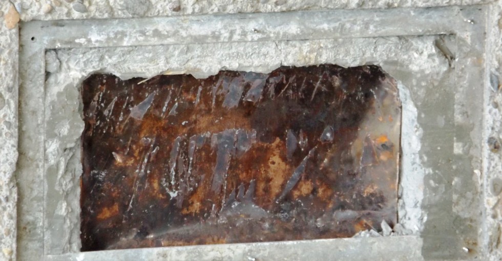 A metal box can be seen encased in mortar.