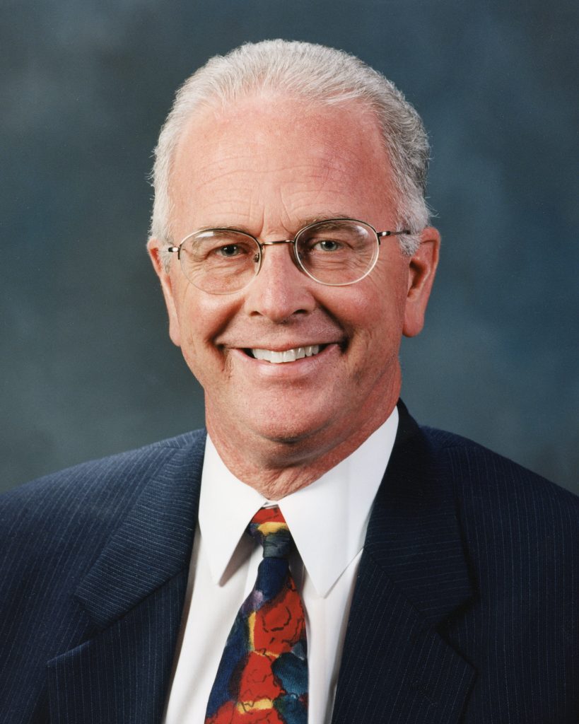 Man wearing tie and glasses.