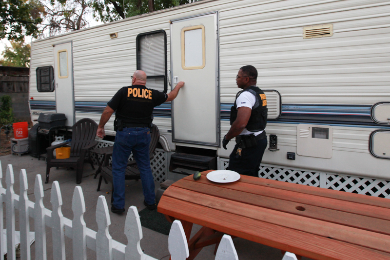 Parole agents knock on a door Halloween night in 2015 during compliance checks.