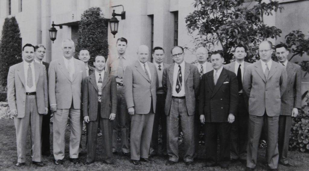 The original staff of Terminal Island's California Medical Facility in 1950. Black and white photo of men wearing ties and jackets.