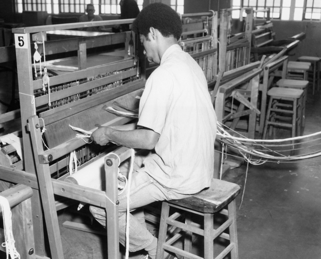 Incarcerated person works a loom at CMF.