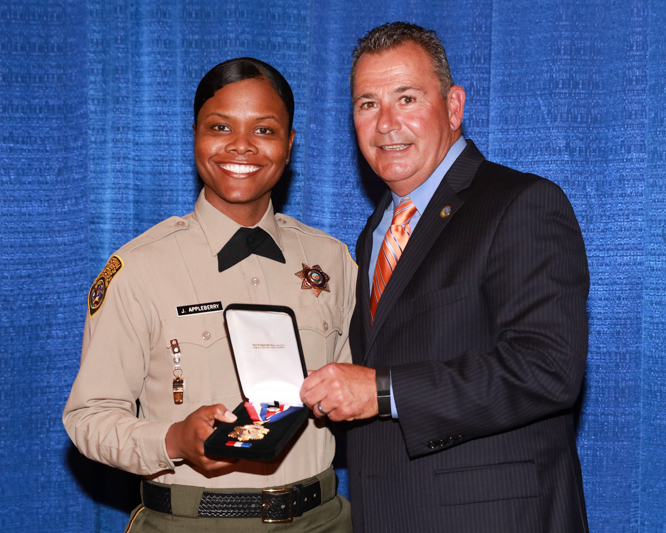 Medal of Valor recipient Correctional Officer Jami Appleberry with Secretary Scott Kernan, 2016.