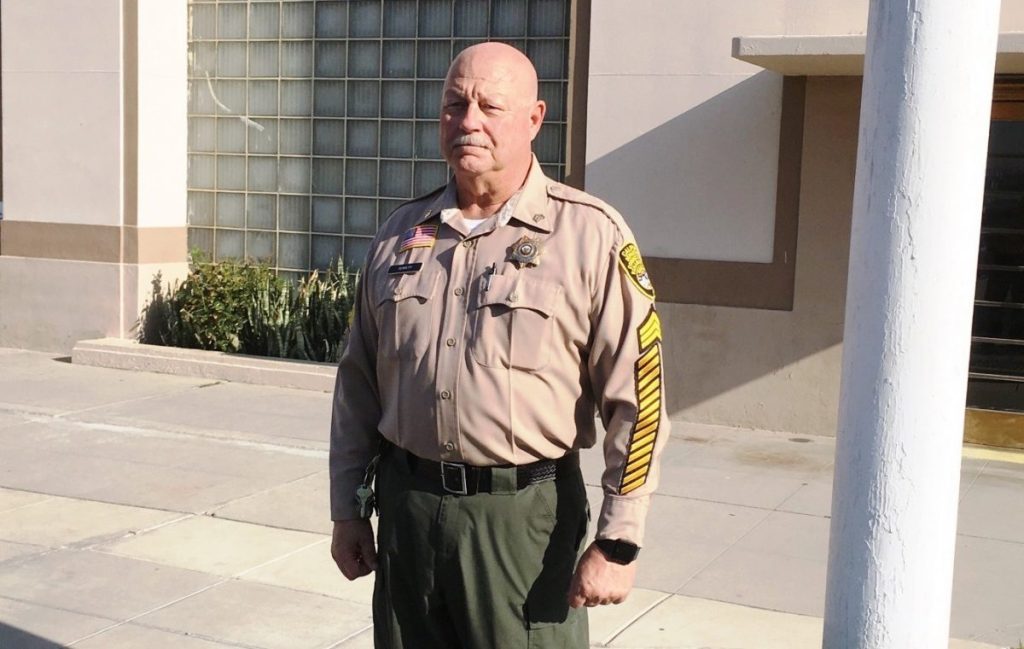Correctional sergeant with 40 years of service marked on his sleeve.