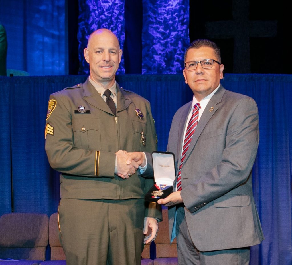 Sgt. Todd Wienke receives Medal of Valor from Secretary Ralph Diaz in 2018.