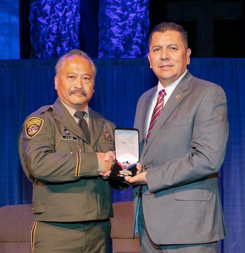Officer Craig Lee and Secretary Diaz at the 2018 Medal of Valor Ceremony.