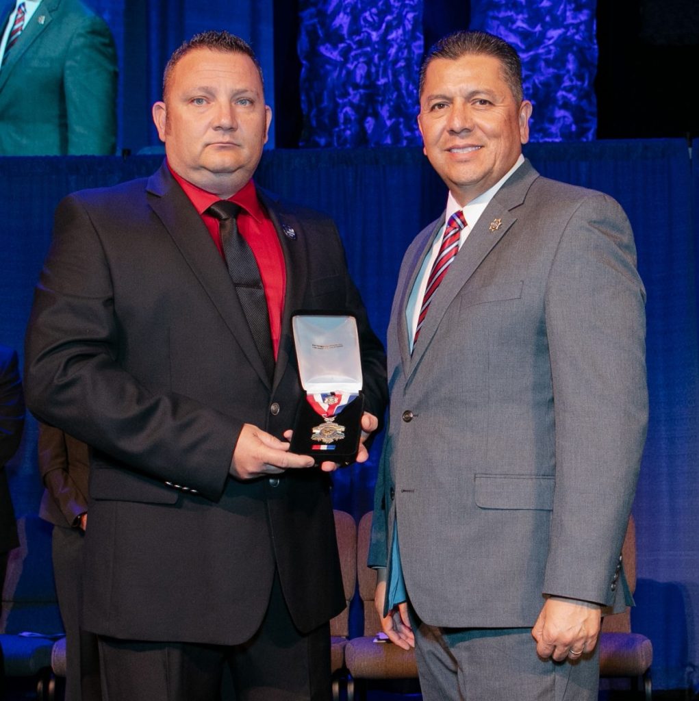 Christopher Pierce, associate warden, accepting Medal of Valor at a 2018 ceremony.