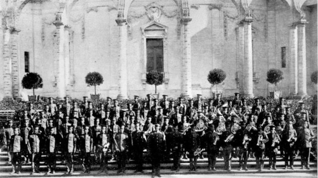 Philippines Constabulary Band with arches and columns behind them.