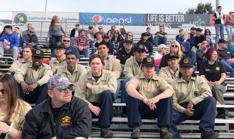 Pine Grove participants enjoy watching the Pig Bowl Guns and Hoses charity football game.