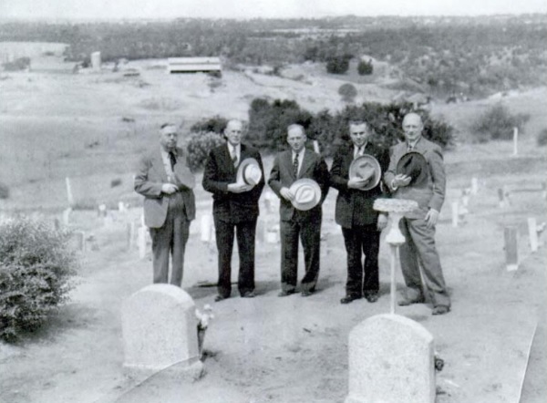 Folsom prison memorial day shows five men standing in the cemetery.