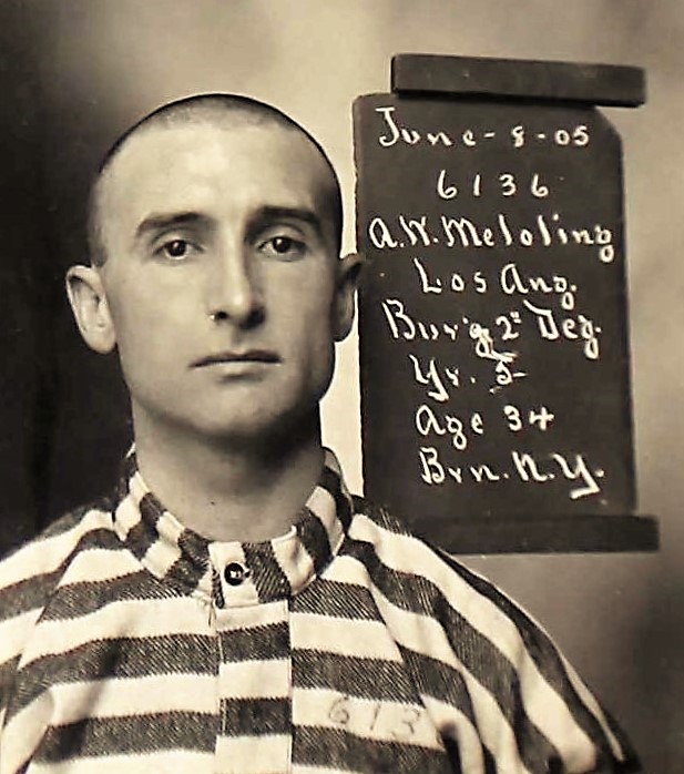 Man with shaved head wears striped shirt. A sign next to his head reads "June-8-05, 6136, A.W. Meloling, Los Ang., Bur'g 2nd deg., Yr. 5, Age 34, Brn. N.Y."