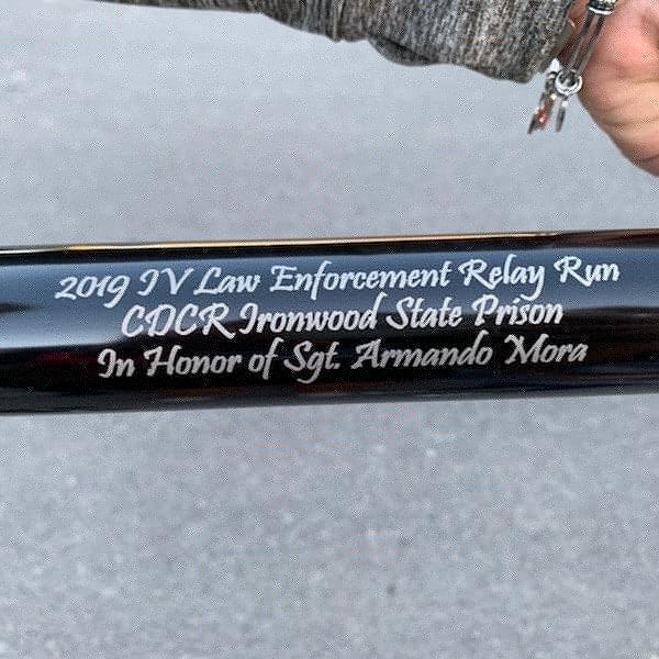 A metal baton with the words 2019 I.V. Law Enforcement Relay Run, CDCR Ironwood State Prison, In Honor of Sgt. Armando Mora.