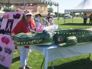 Woman with alligator toy.