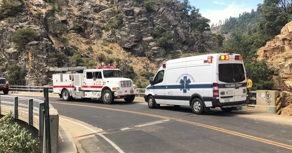 Ambulance and fire engine on a bridge.