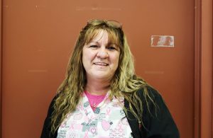 Woman wearing nurse scrubs.