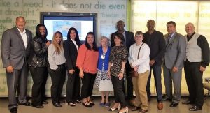 Parole staff and academy instructors stand in a Holocaust museum and the Anne Frank exhibit in 2019.