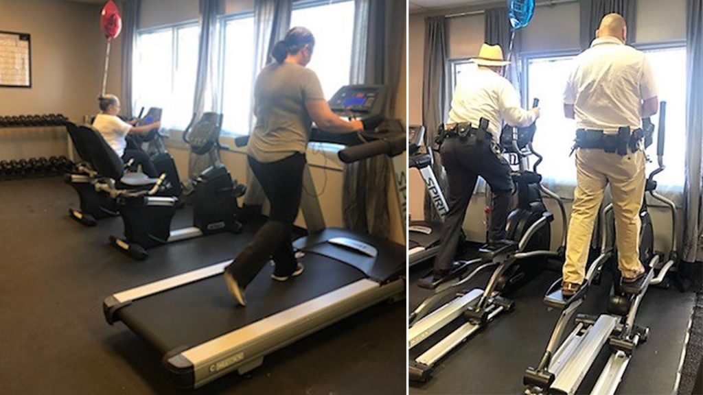 Men and woman use exercise equipment at the new staff fitness center.