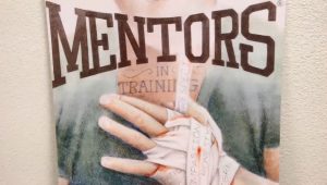 A posted showing a bandaged hand and the words Mentors in Training.