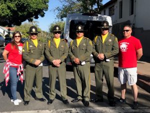 People in dress uniforms and two wearing team tee-shirts.