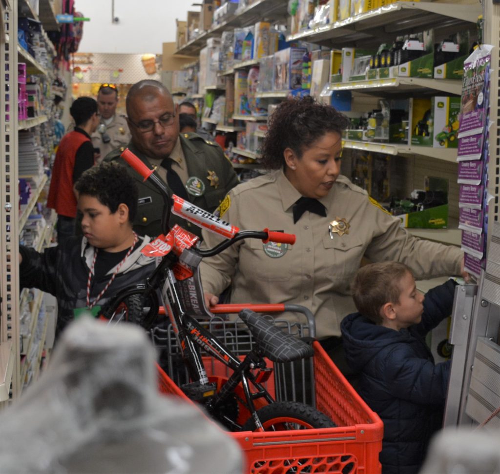 Officers escort children through a store.