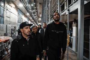 Sacramento Kings players walk through a prison cell block in Folsom.