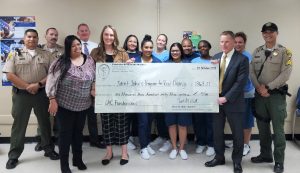 Folsom Women's Facility donates a check to the charity, St. John's.