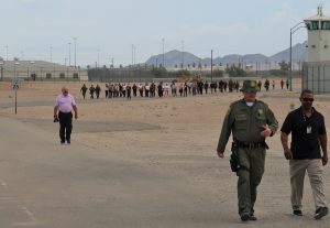 People walk on prison grounds.