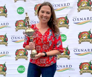 Woman smiling and holding a trophy