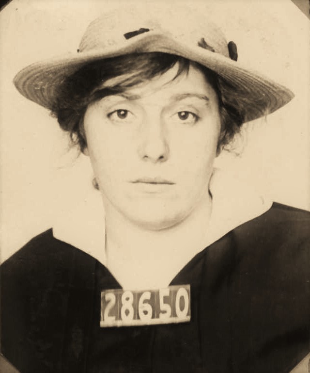 Woman wears a hat and the numbers 28650 in her prison mugshot.