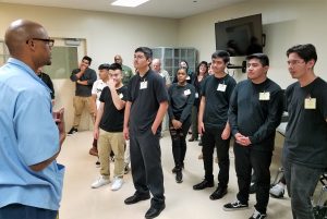 High school students listen to a prison inmate talk about rehabilitation.