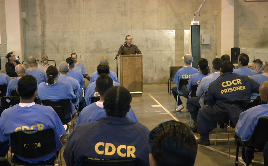 Wasco State Prison chaplain speaks to inmates.