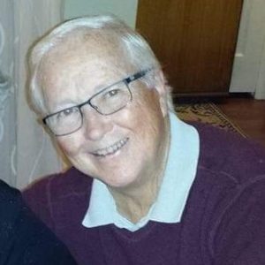 William Anderson smiles, leaning into photo.