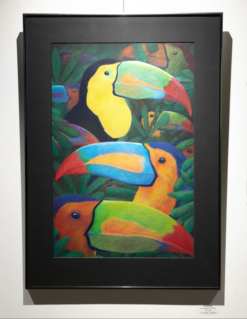 Three toucans with colorful beaks sit among foliage in this inmate produced piece of artwork.