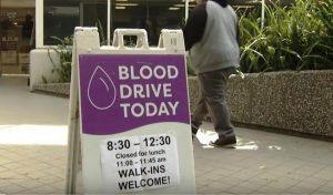 blood drive sidewalk purple signage