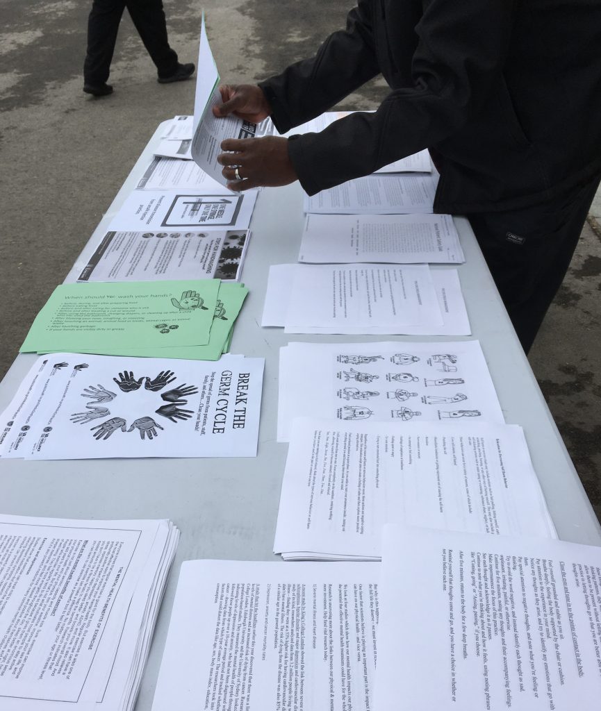 A table is filled with various informational handouts.