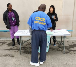 At LAC prison, people speak to staff about patient safety and health care.