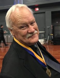 Lon Regerh wearing a water polo medal.