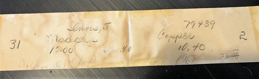 A yellowed piece of paper on the back of the art read, "Inns, J., Madcap, 10.00, .40, Folsom Art Show, 79439, copper, 10.40, 1967." There are also the numbers 31 and 2. The year 1968 is written to the side but it's scratched out. 