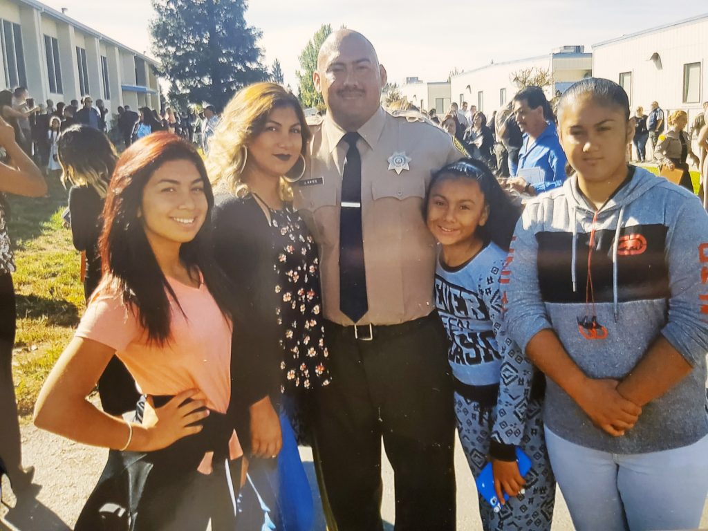 Man in correctional officer uniform with his wife and three daughters.