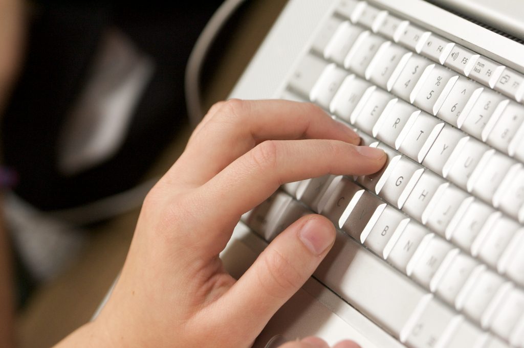 Individual using computer keyboard