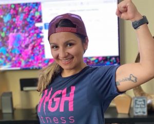 Work-life balance story shows a woman flexes muscle while smiling into the camera.