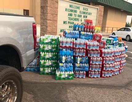 A truck sits beside a stack of donations for firefighters and evacuees.