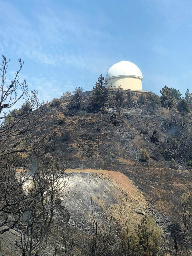 Observatory at top of burned hillside.