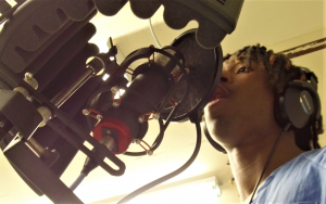 San Quentin inmate sings into a microphone.
